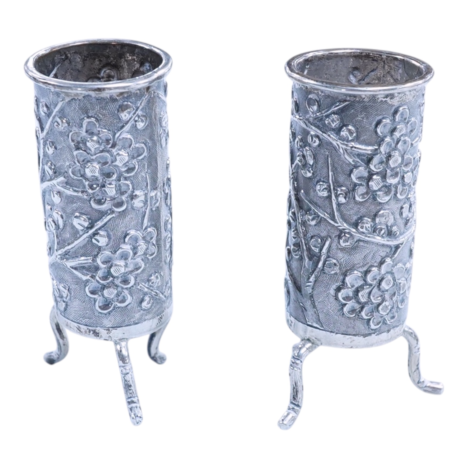 A pair of late 19th/early 20th century Chinese Export white metal cylindrical toothpick holders, by Wang Hing, Hong Kong, stamped 'WH90', on tripod feet, height 6cm.